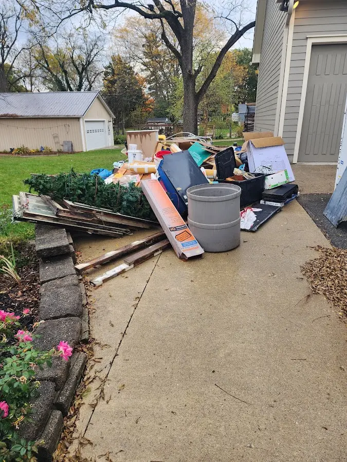 Dumpster being loaded with debris for Roofing Dumpster Rental in White House
